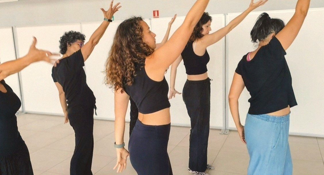 Mujeres en movimiento con los brazos en alto durante una sesión